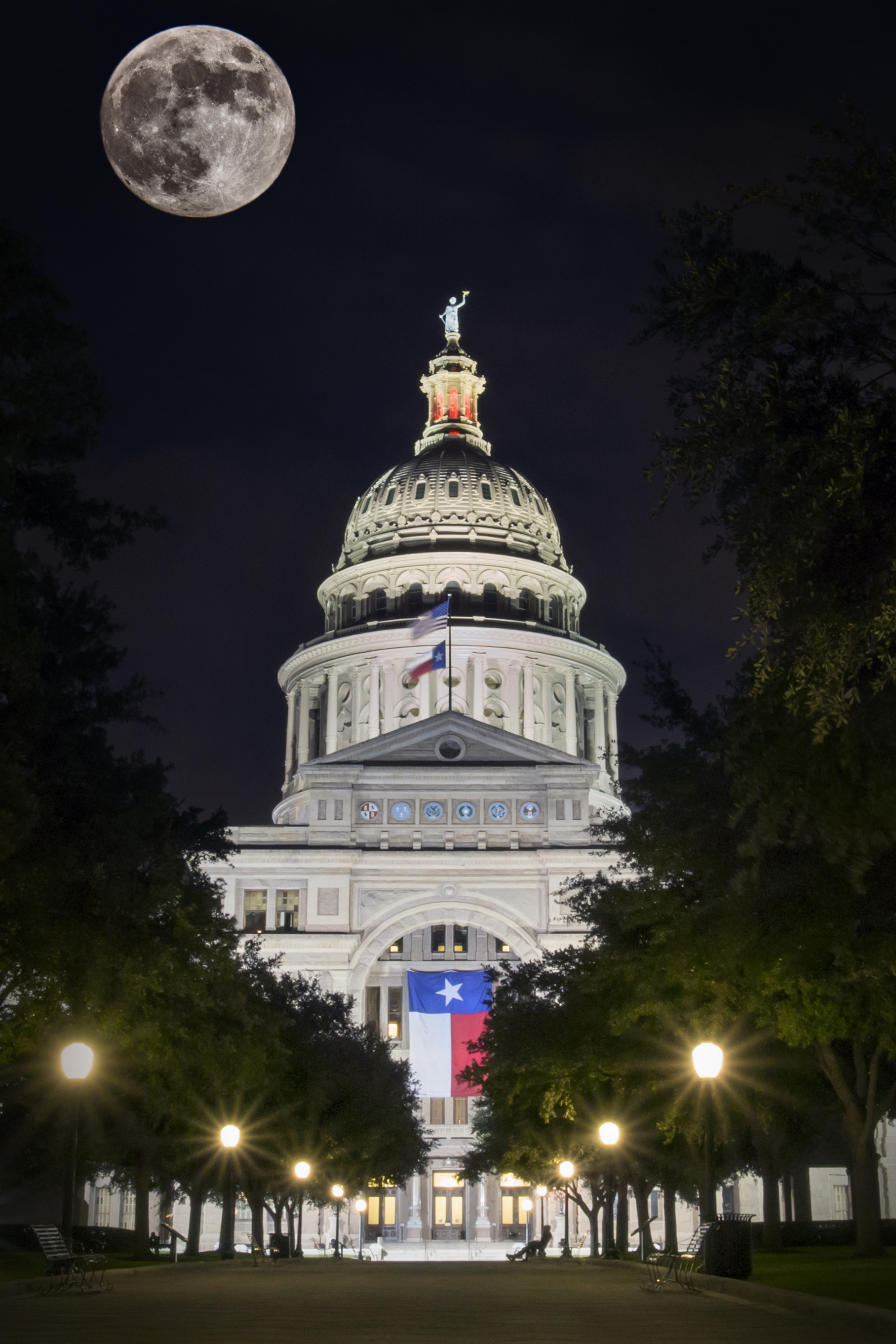 The moon composited into an image of the Texas State Capitol. 