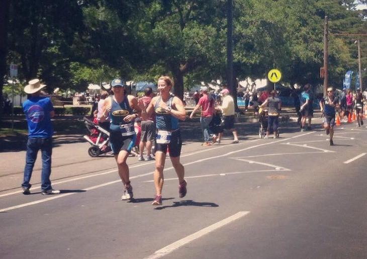 Mary running (without cap) with friend Amy (wearing cap)