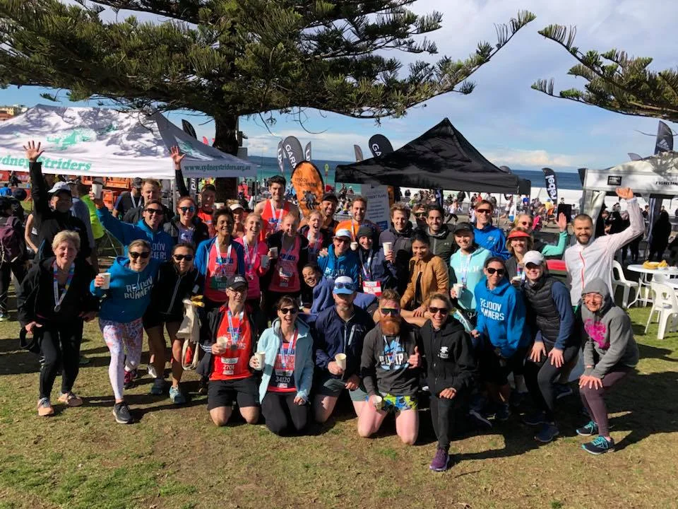 City to surf 2018 Rejoov runners post race rugged up and ready to party
