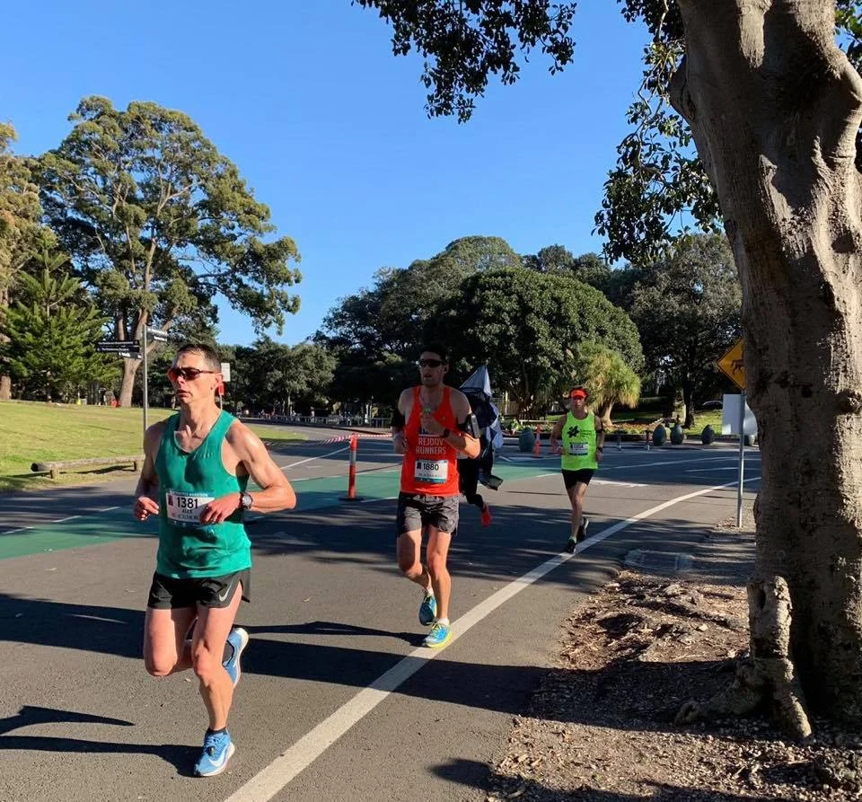 Running through Centennial Park and a tiny bit of shade on a hot day! (Jamie in the stand out orange singlet)