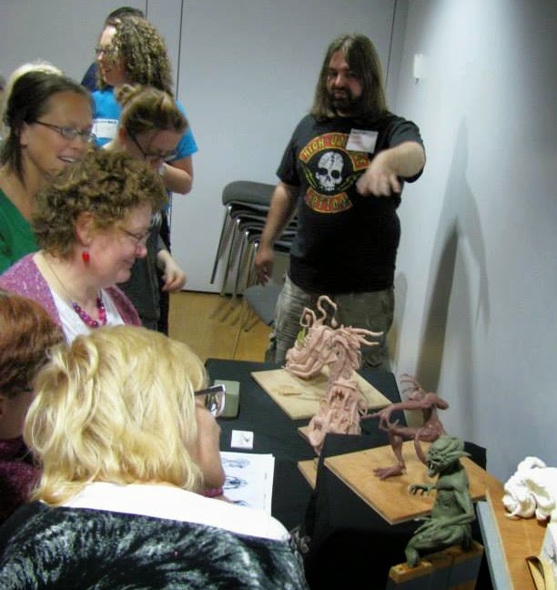 Peter Cooper encouraging students to view his sculptures. 