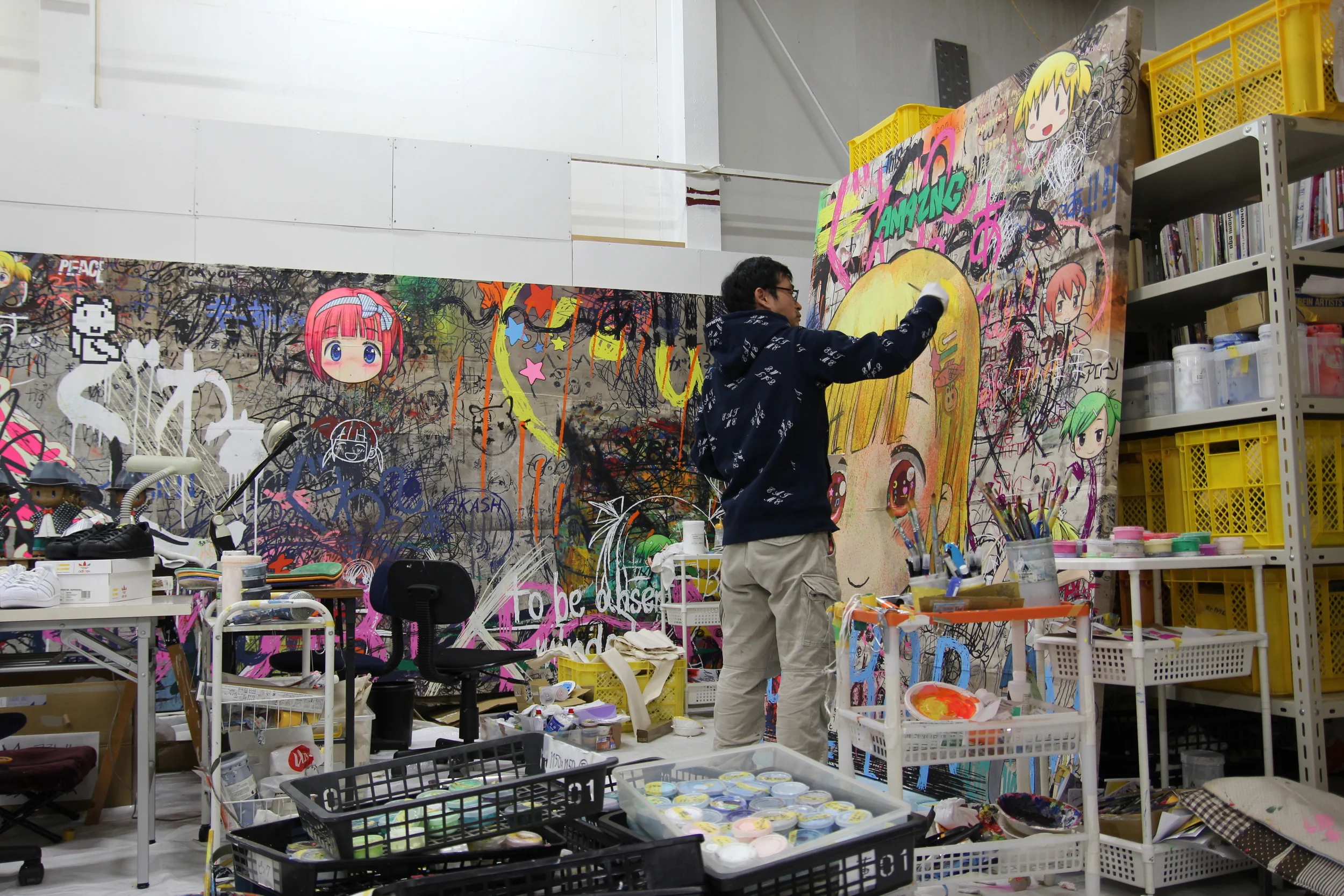 The artist Mr. at work in his studio