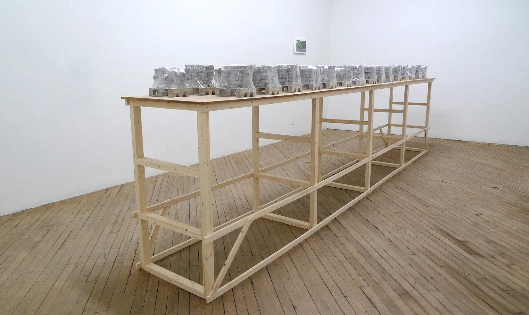 Eliza Myrie Building a Wall Through My Father (dress rehearsal) concrete, wood, plastic film, pine, MDF each element approximately 6 x 8 x 10 inches table, 192 x 22 x 50 inches 2016