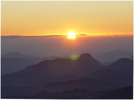 A bluish veil far below the Holy Summit dissolves with the dawn to reveal the crests of a seascape fixed in granite since the blush of creation.
