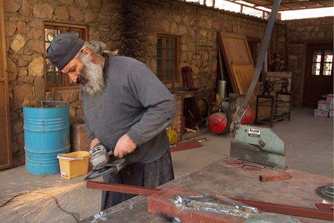 Monk doing maintenance repairs at the monastery. (Picture courtesy of Massimo Pizzocaro)