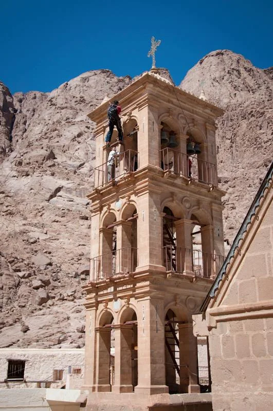 Monastery bell tower being "conquered" by Michael, the mountain-climber
