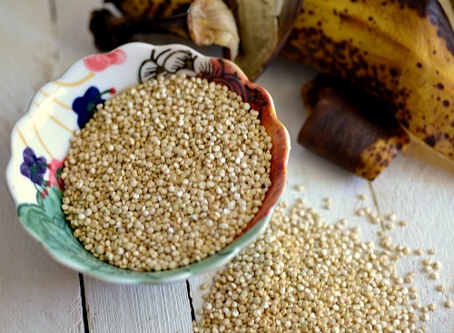 A bowl of quinoa on a wooden table