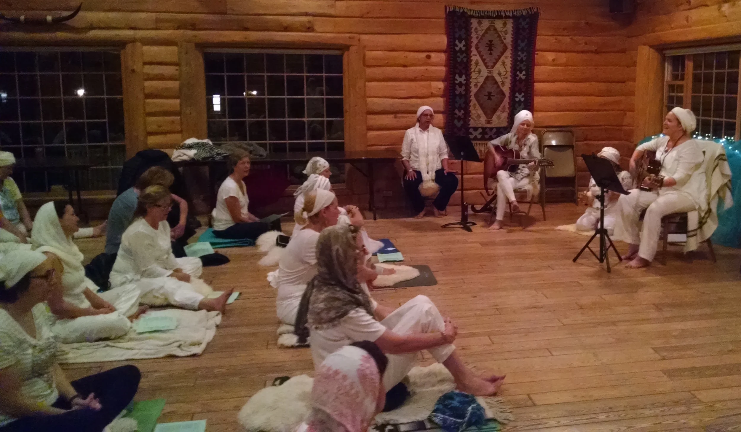 Preet Leading Chants in Log Lodge.jpg