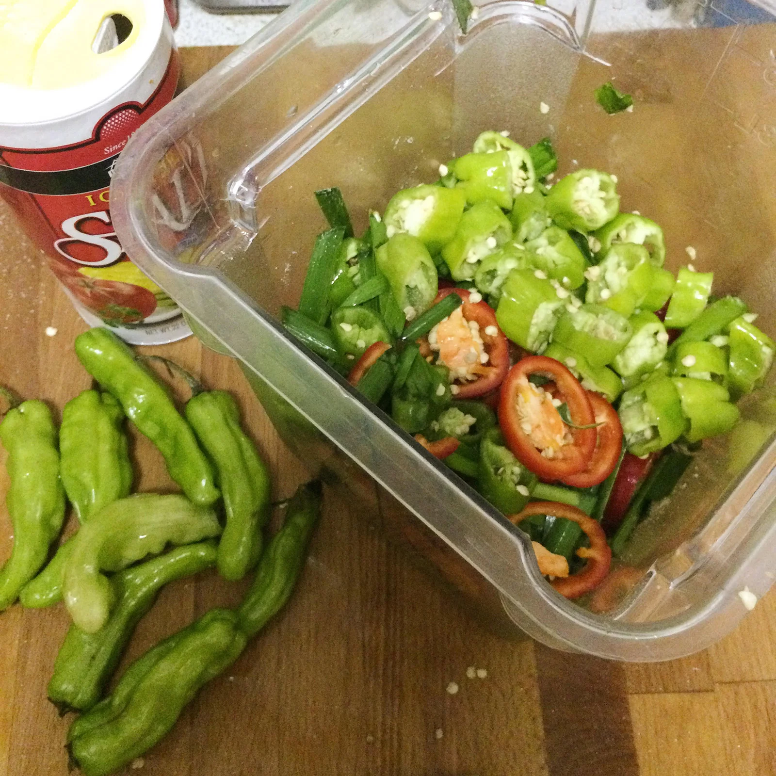 Red cherry peppers, green Korean peppers, and green shisito peppers mixed with garlic chives and salted heavily
