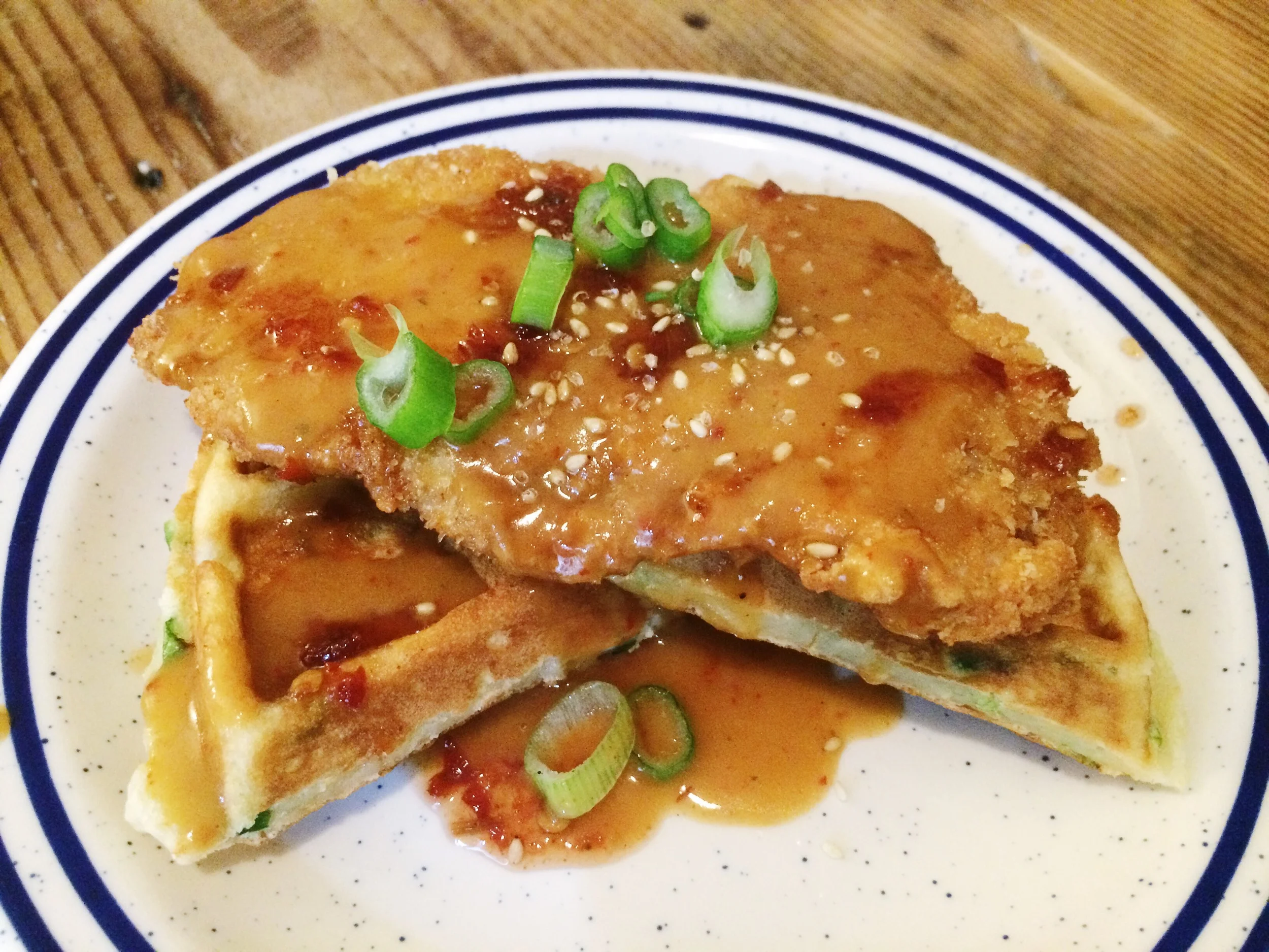 Pork Donkatsu + Kimchi Scallion Waffles smothered in donkatsu gravy & sambal maple syrup