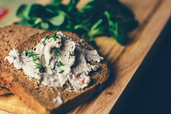 Image of toast with hummus spread over it as a healthy snack to boost weight loss