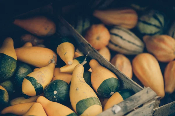Image of a wooden box full of squash which are full of complex carbohydrates