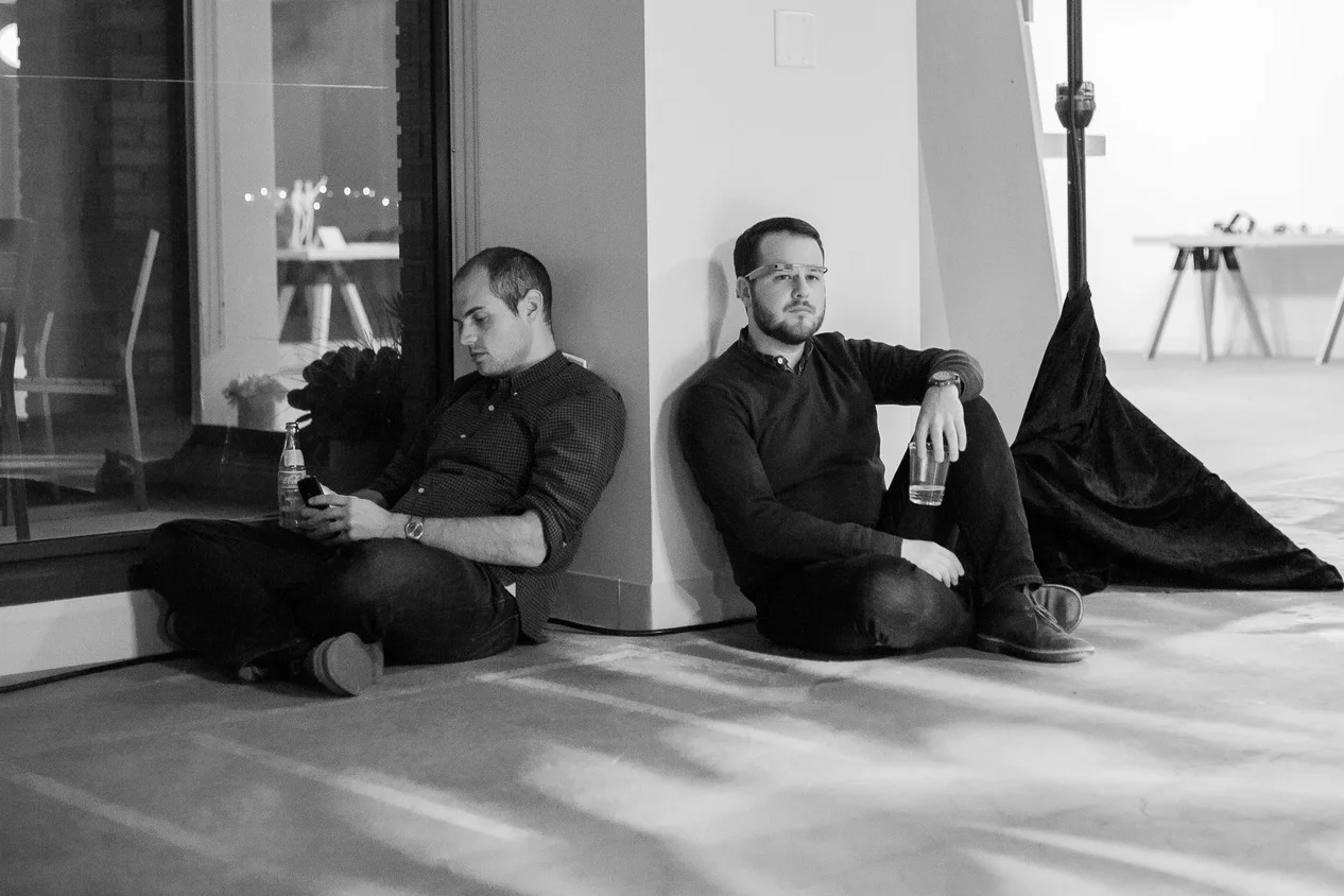 After a series of back-to-back long days, followed by evening events, two Glass team members take a moment to rest.