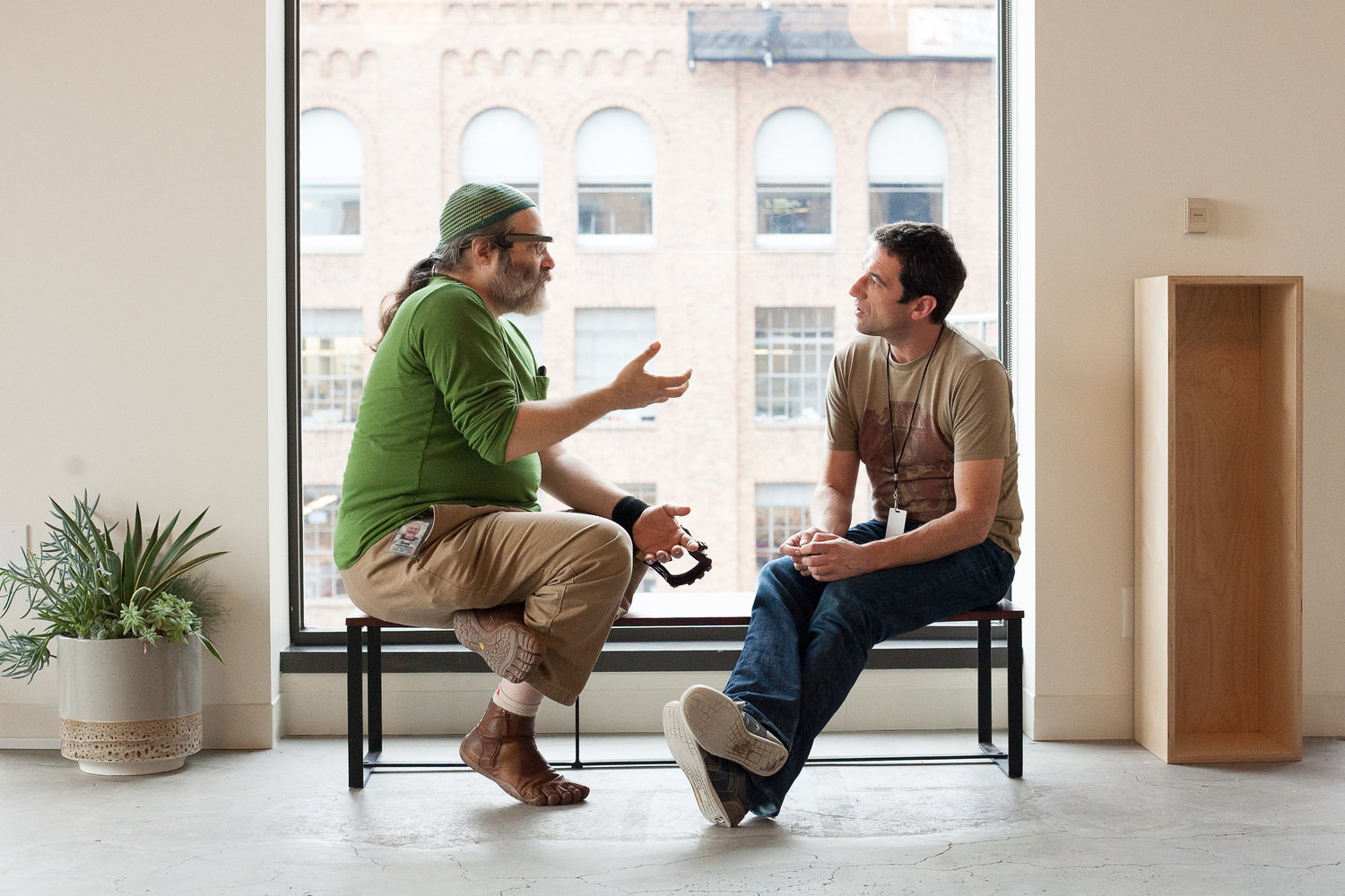 Inside the San Francisco office, Greg Priest-Dorman talks with a participant at Glass's two-day GDK launch and hackathon in November 2013.
