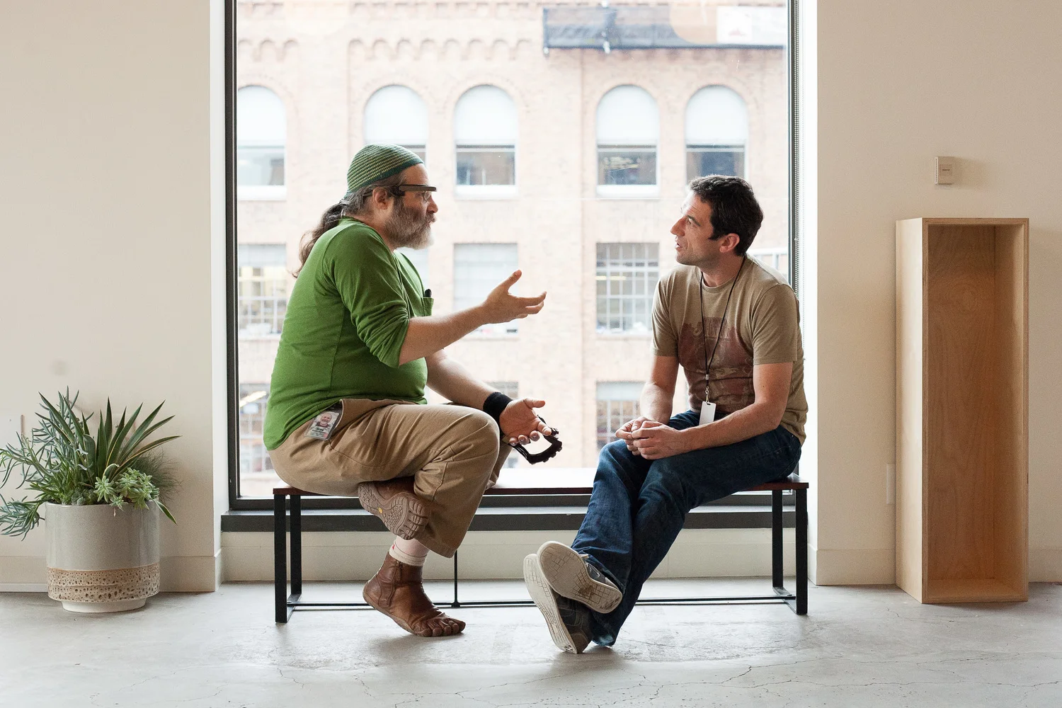 Inside the San Francisco office, Greg Priest-Dorman talks with a participant at Glass's two-day GDK launch and hackathon in November 2013.