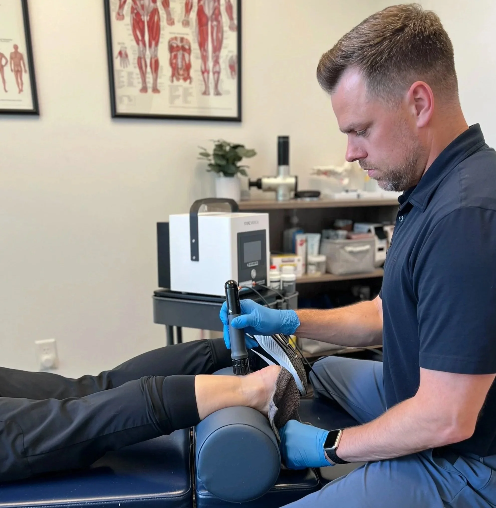 Dr. Reheisse at Revive Sport & Spine in Murray Utah providign shockwave therapy for Achilles Tendinopathy.