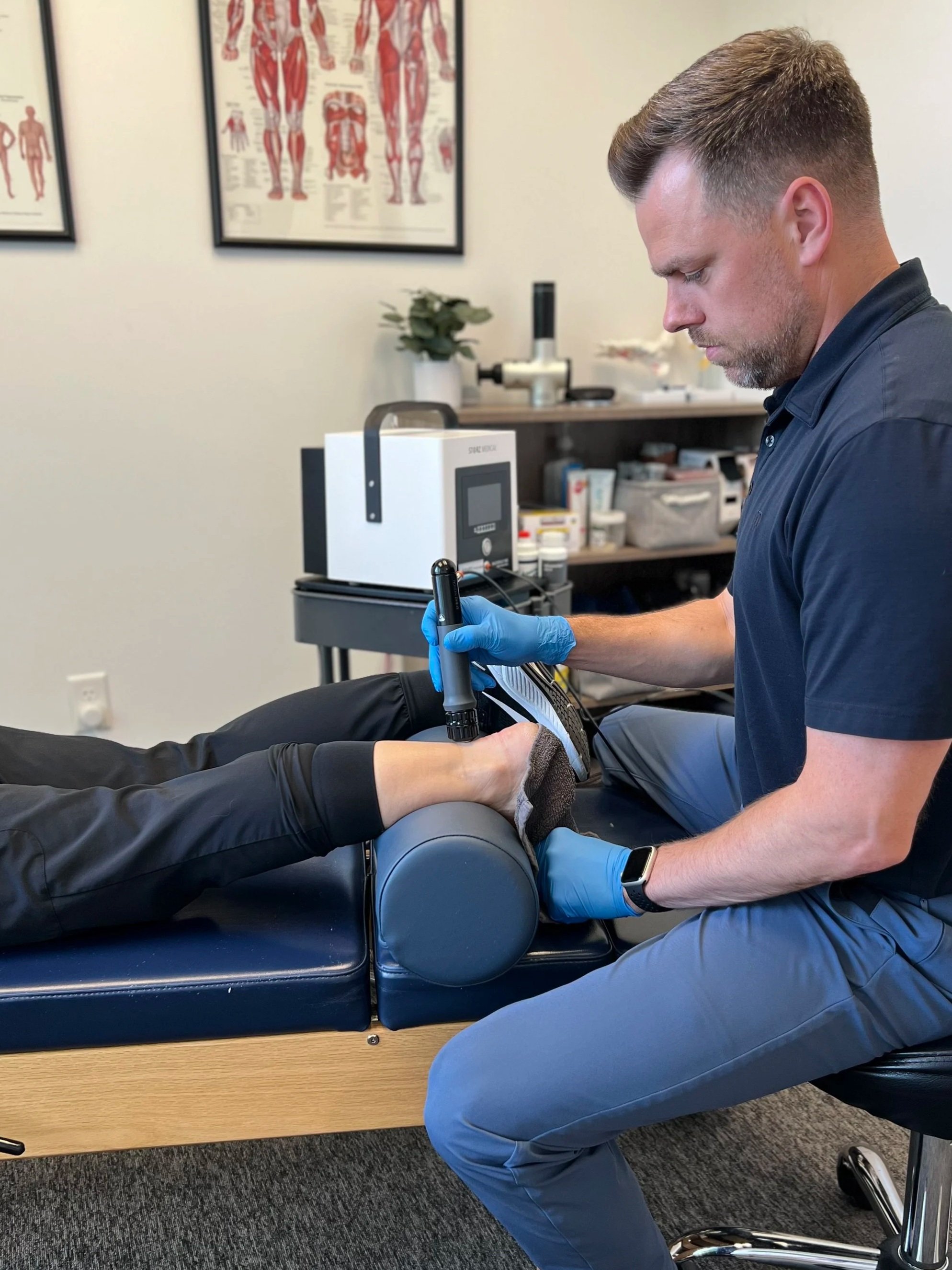 Dr. Reheisse of Revive Sport and Spine, a sports chiropractic clinic in Murray, UT performing shockwave therapy for achilles tendinopathy relief.
