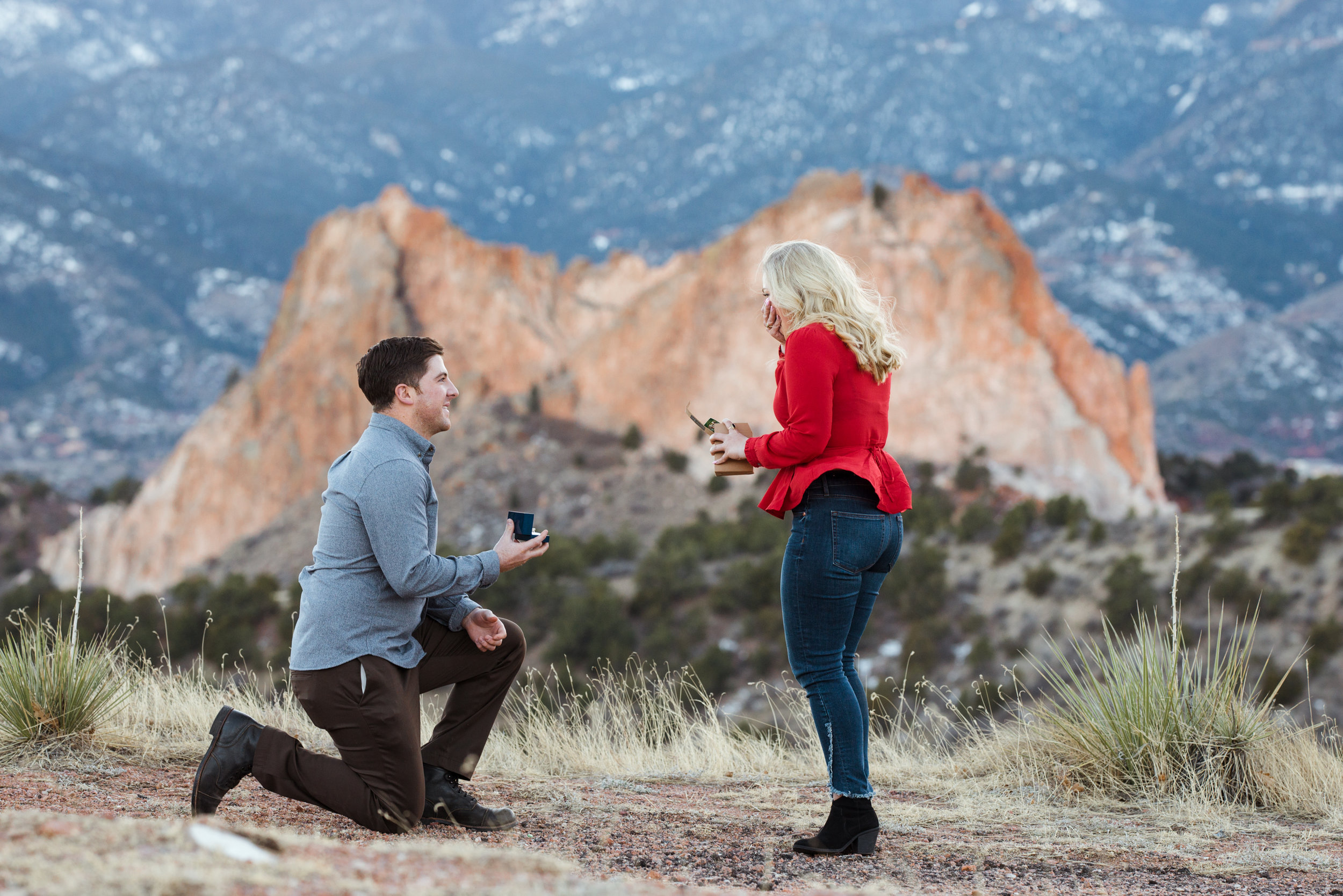 Blaine surprises Christine by getting down on one knee outside Garden of the Gods!