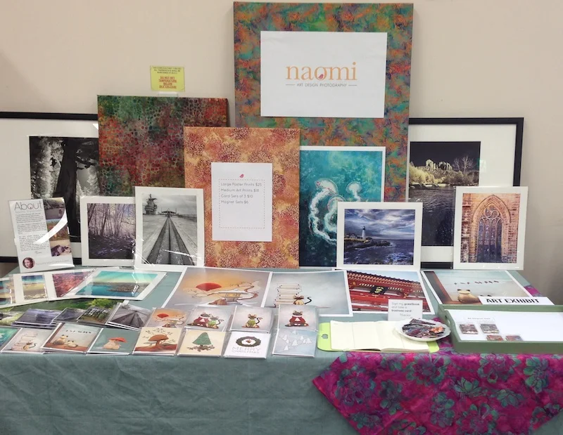 My table at my first craft fair, a fairly casual event. Displaying my photography and siamese cat illustrations.