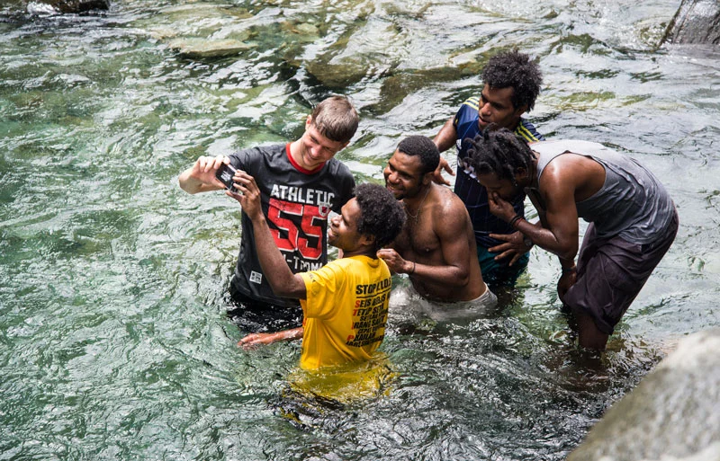 Swimming at a waterfall near where I grew up in Indonesia. Anson is sharing the video he got of them jumping in.