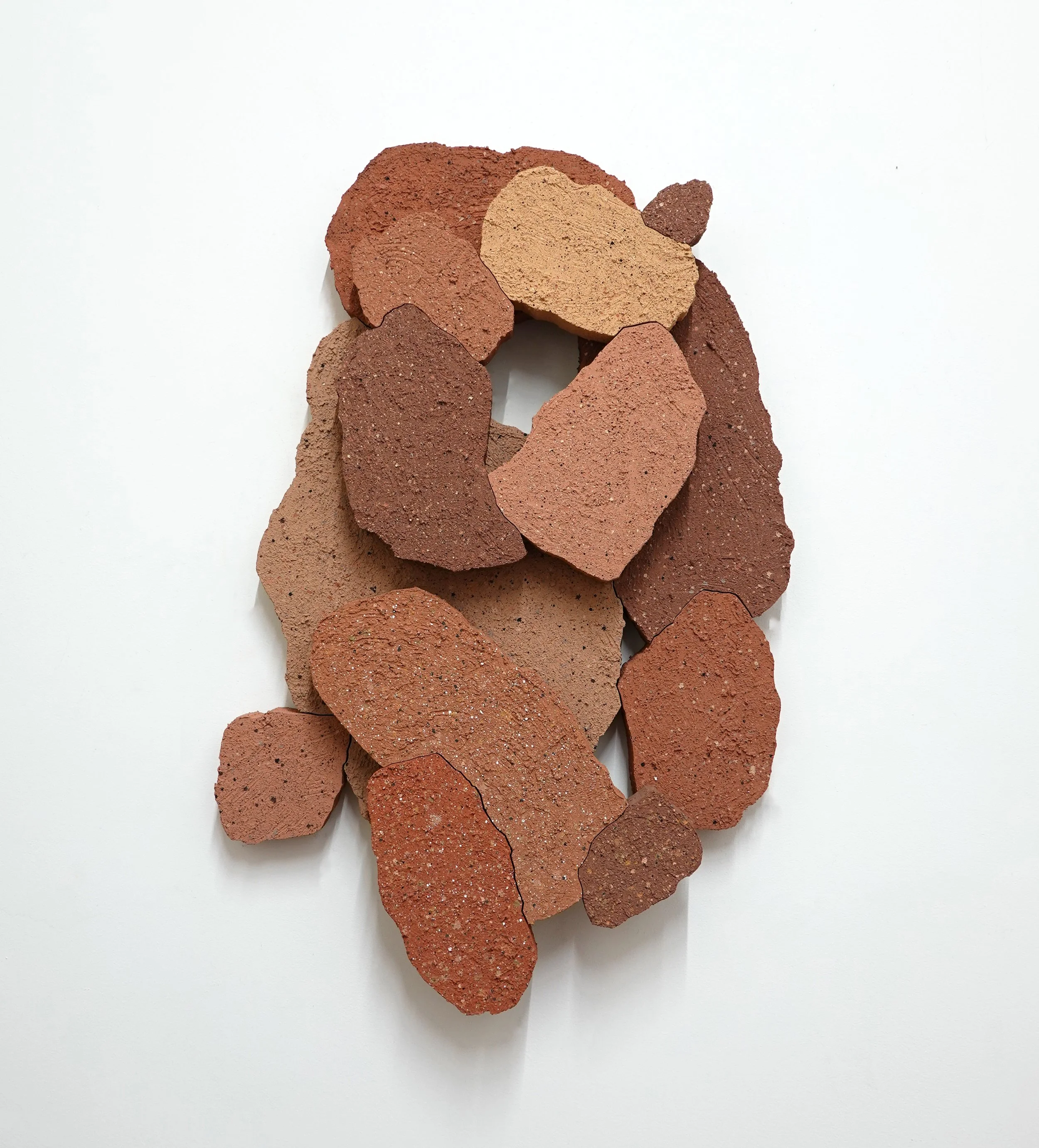 HEADSTONE - landslide, 2026, stucco, acrylic and flashe on wood, 32 x 21 x 3.5” 
