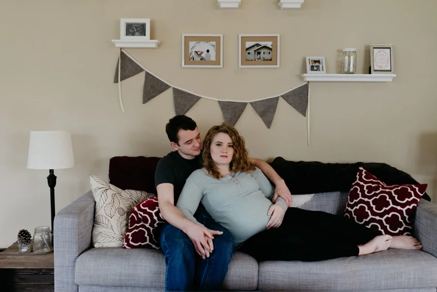 expectant couple on sofa