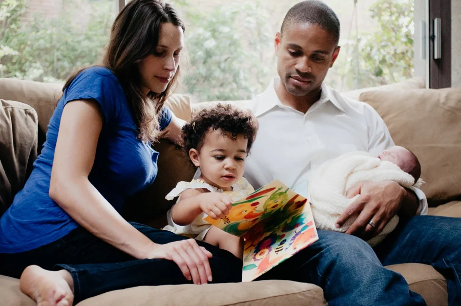 mom and dad reading with toddler