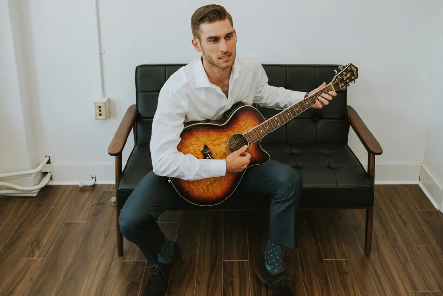 groom playing guitar