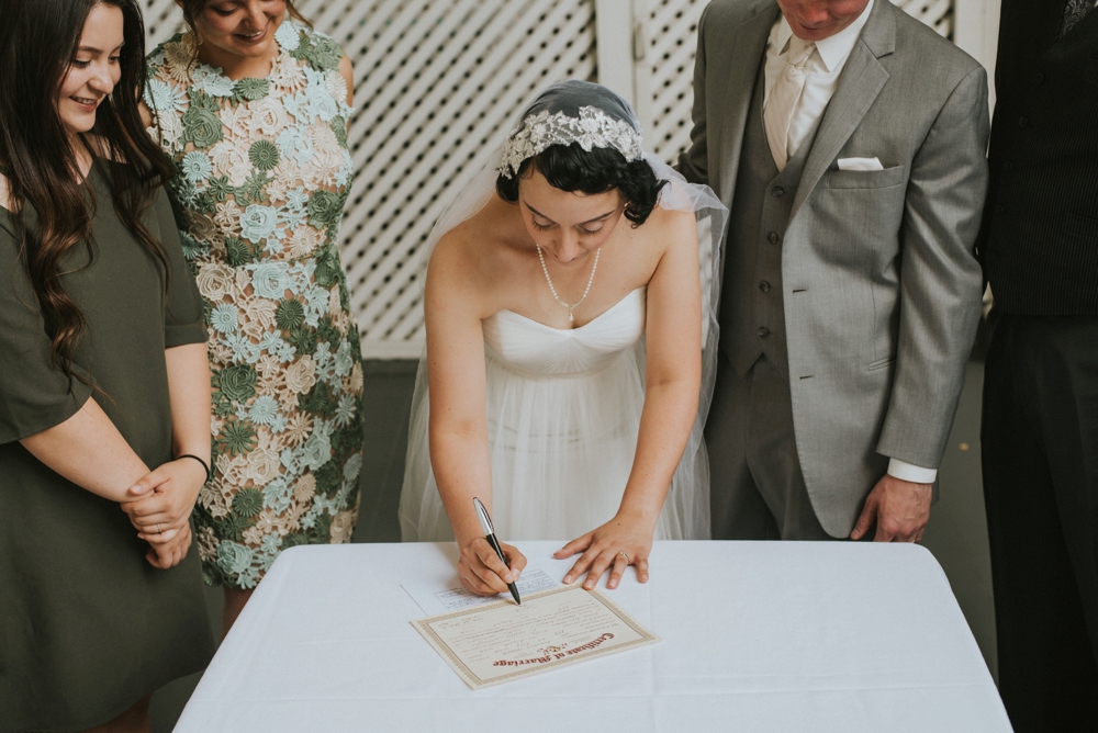 bride signing marraige certificate