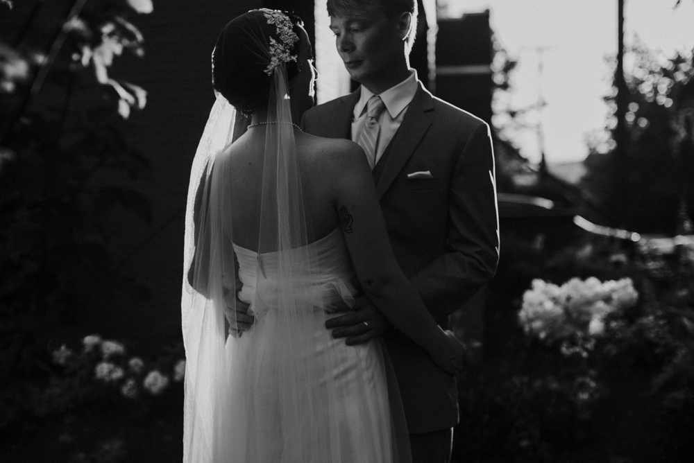 groom embracing bride