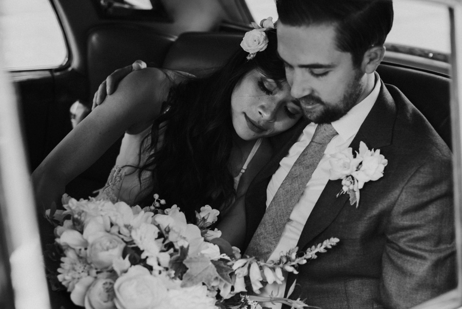 bride and groom in classic car