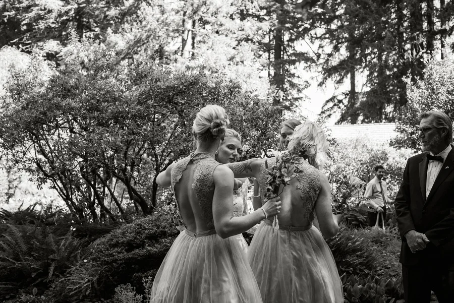 Brides maids helping bride