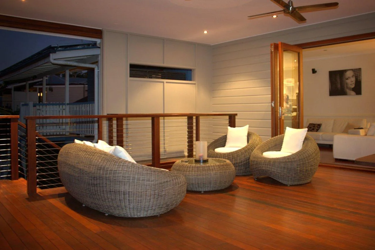 Deck & House Renovation On Brisbane Queenslander. Timber Bi-fold Doors, F.C. Clad Walls For Privacy. Ceiling Fans & Downlights. Wynnum