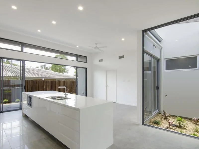 Modern Kitchen With Indoor Atrium. Large Stacker Doors With Windows Above. Sunshine Coast, Queensland