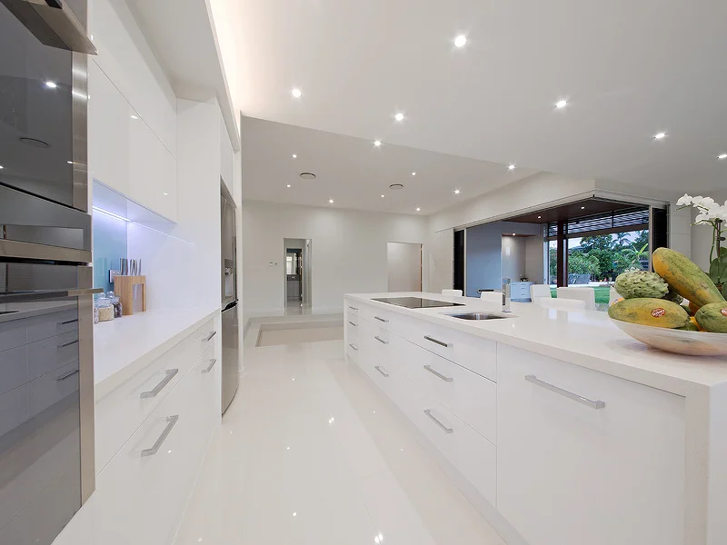Modern kitchen with stone bench tops and top of the line appliances. House design by Empire Design & Drafting