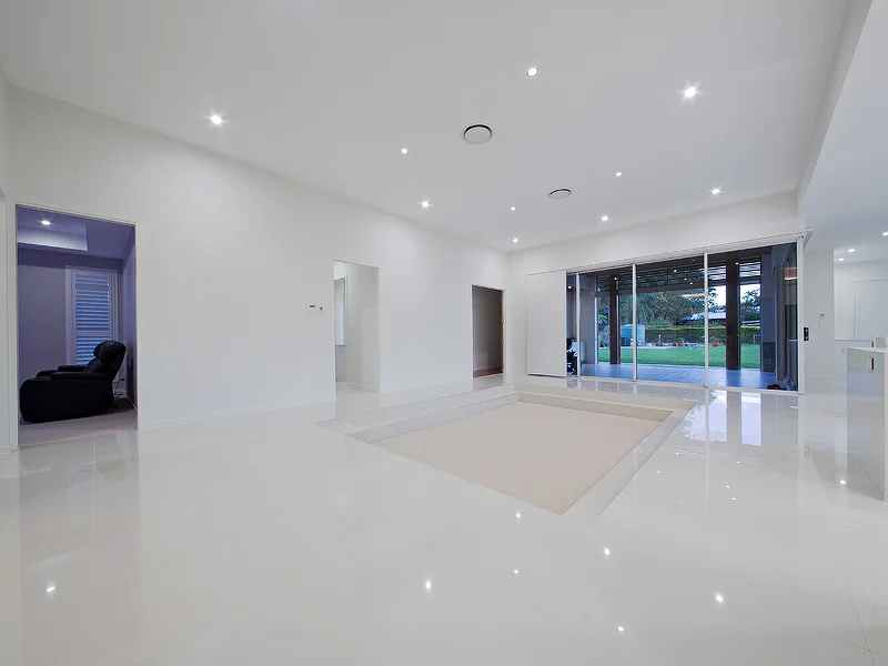 Sunken lounge room with 3.5m high ceilings. House design by Empire Design & Drafting