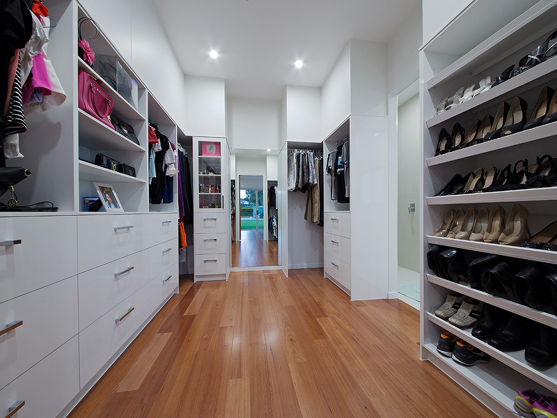 Walk in Robe with open shelving and display cases. House design by Empire Design & Drafting