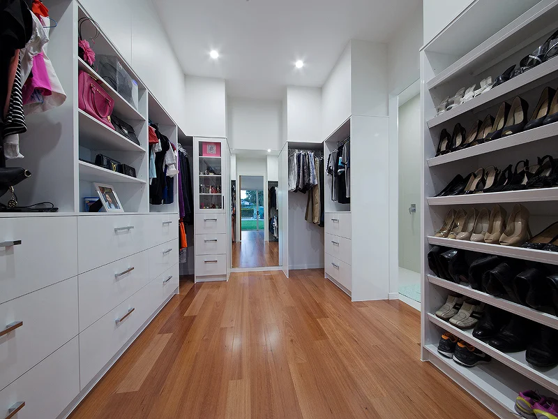 Walk in Robe with open shelving and display cases. House design by Empire Design & Drafting