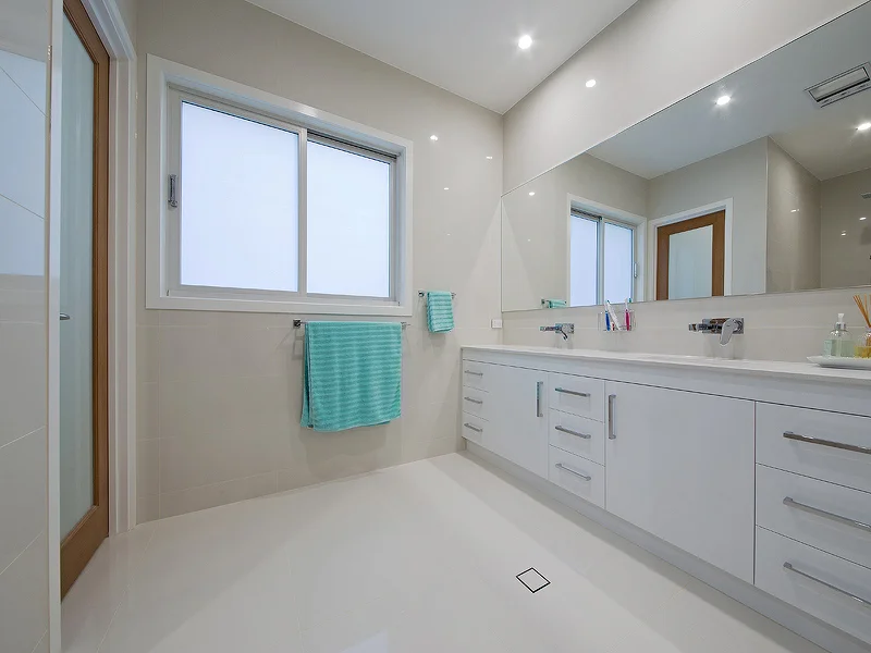 Ensuite with double stone vanity and open shower. House design by Empire Design & Drafting