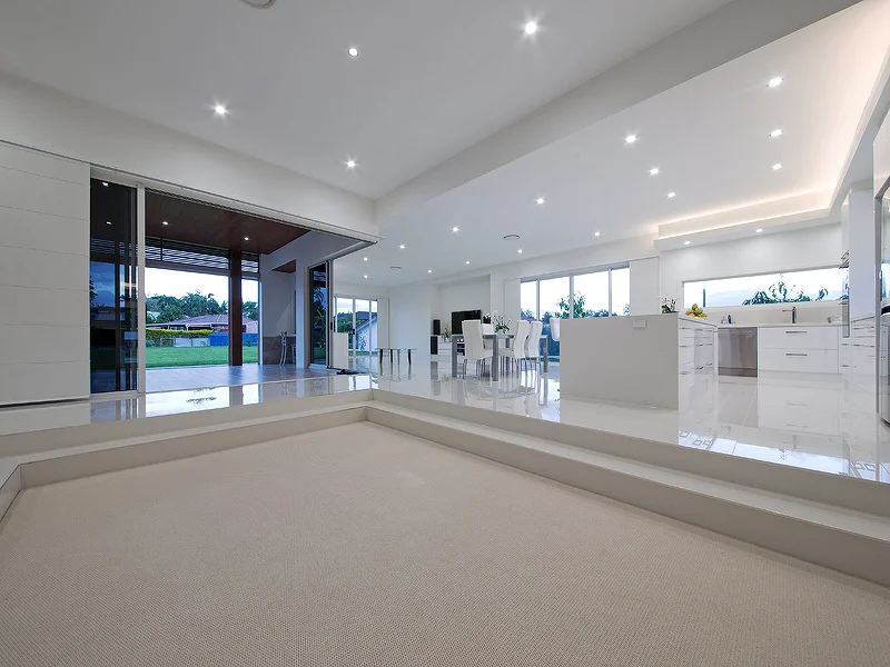 Sunken lounge room with large corner stacker doors leading to Alfresco. House design by Empire Design & Drafting