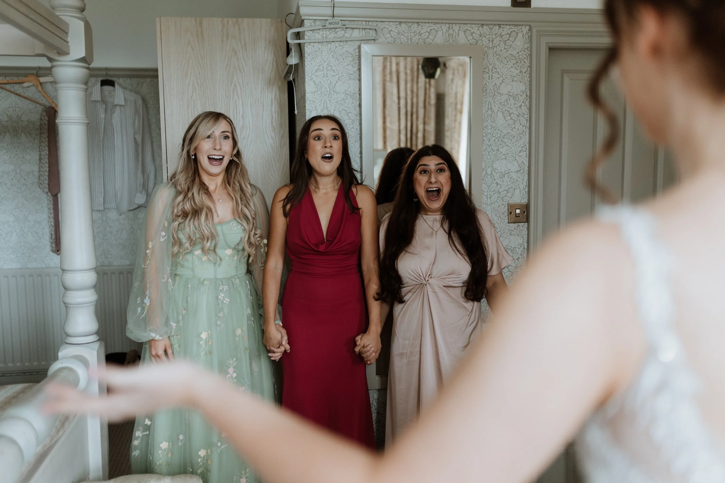  The reactions of the brides friends during a first look in the Lake District. 