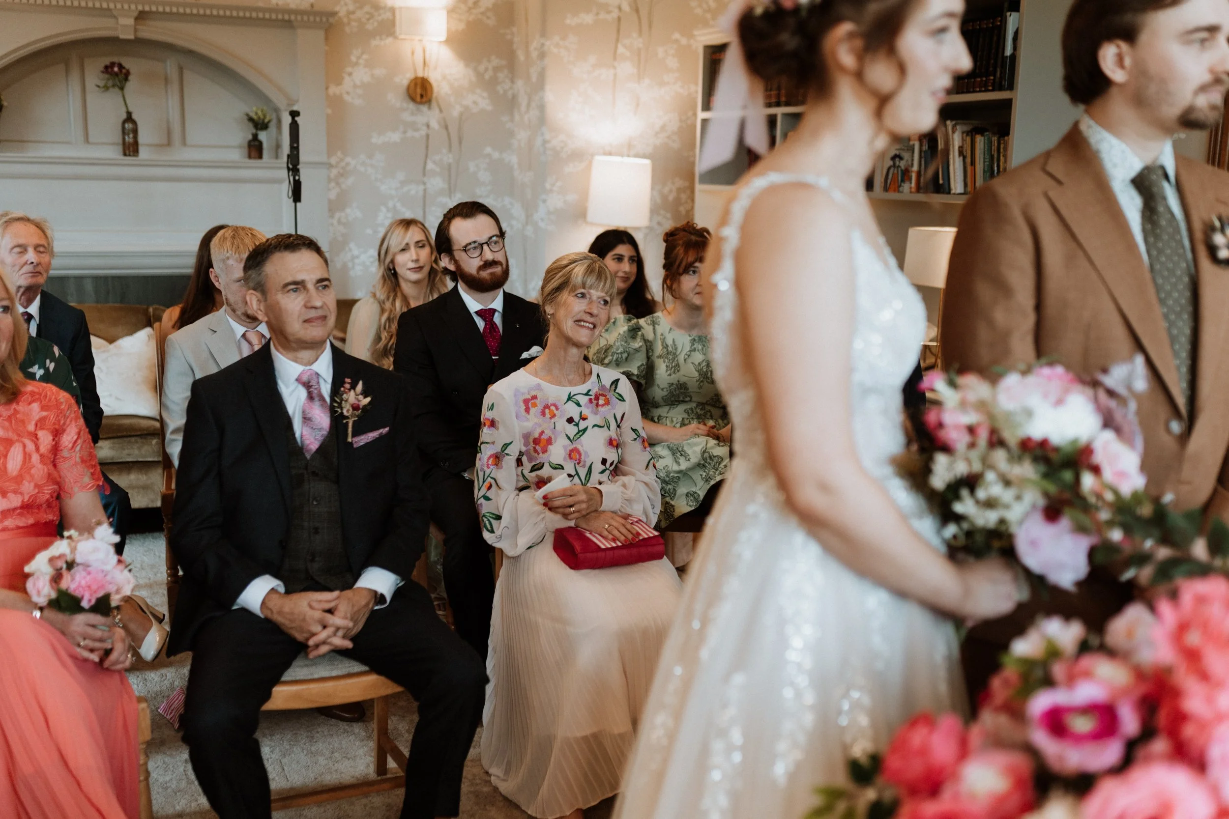  Guests watch the bride and groom during their ceremony in the Lake District.  