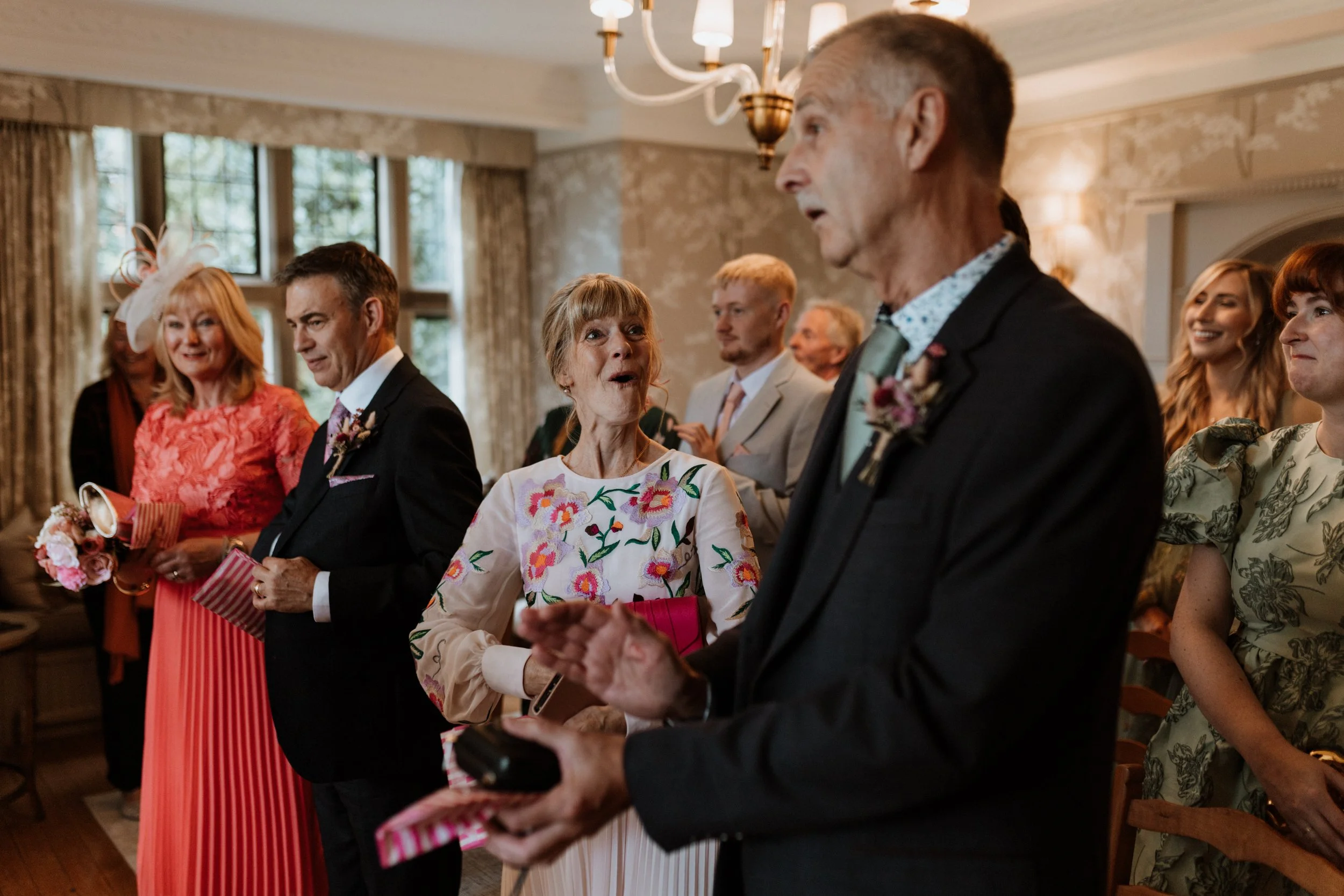  The guests react to finding out the bride and grooms new second name.  