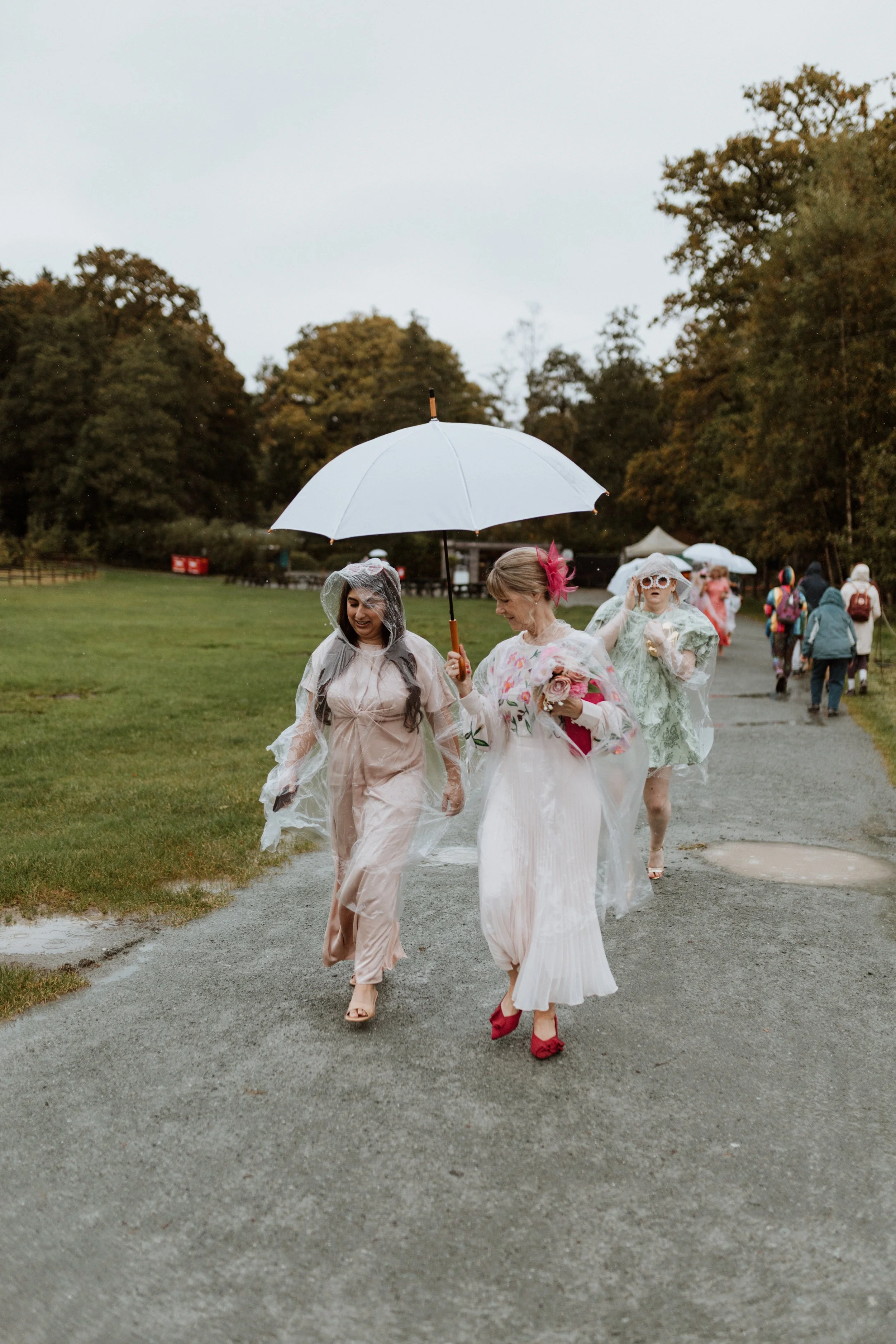  Two guests walk under and umbrella in the Lake District.  