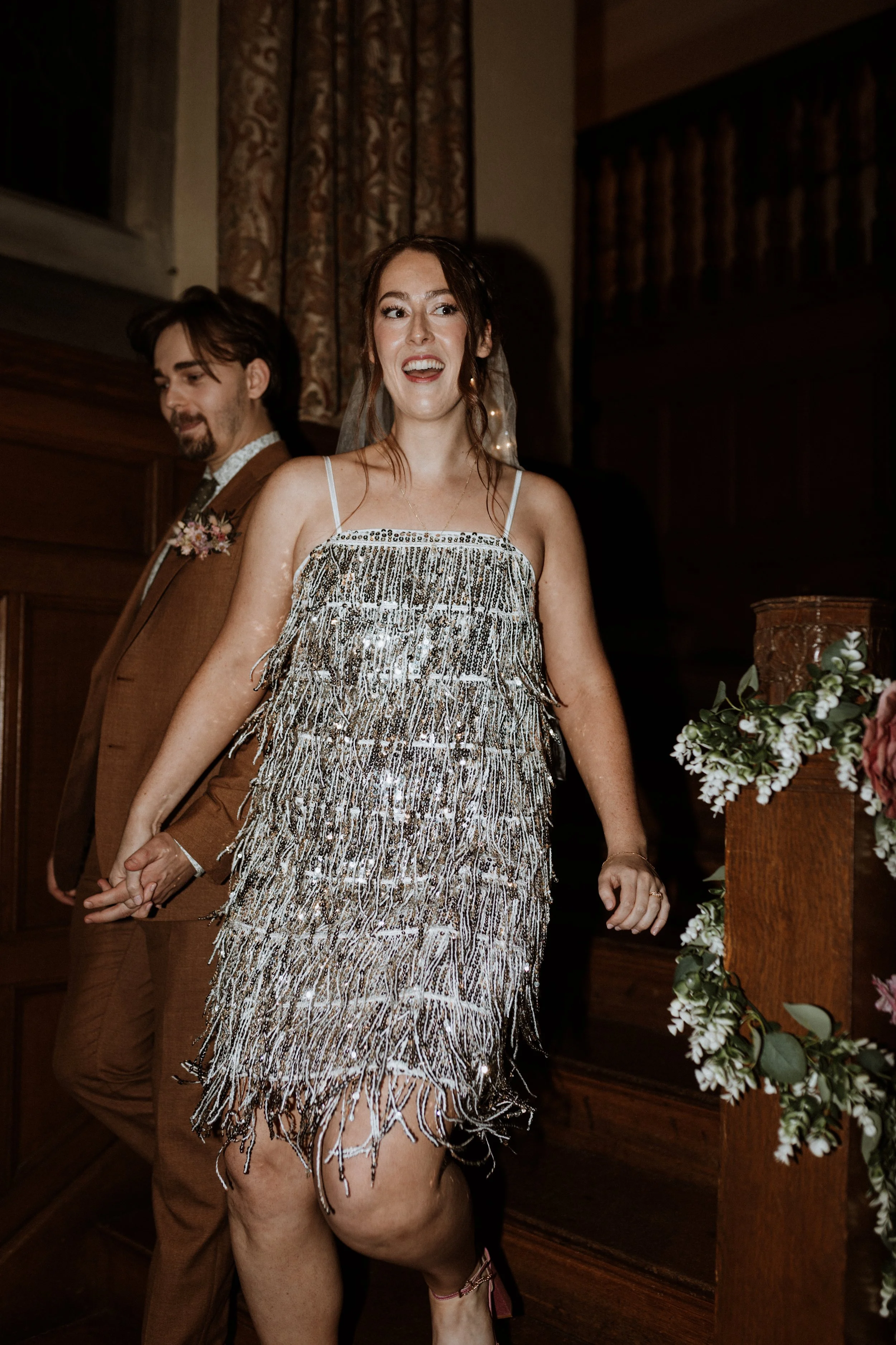  The bride and groom enter the dance floor together, the bride wears a sparkly sequin dress.  