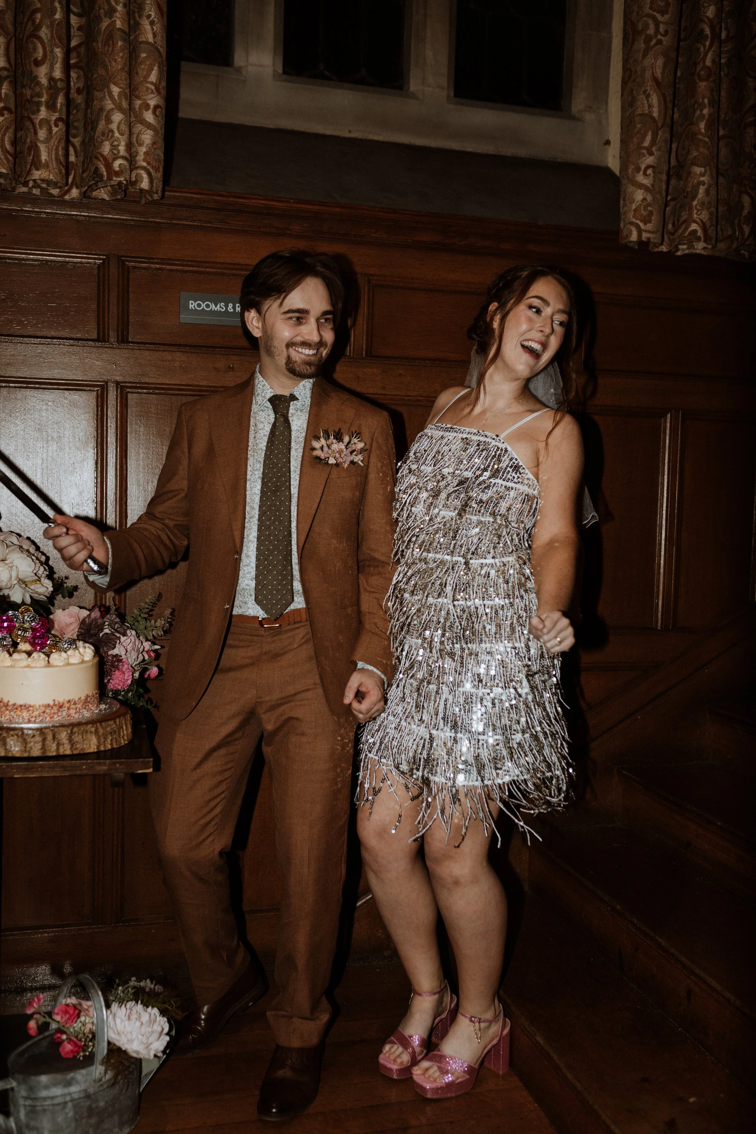  The bride and groom cut their wedding cake in the Lake District.  