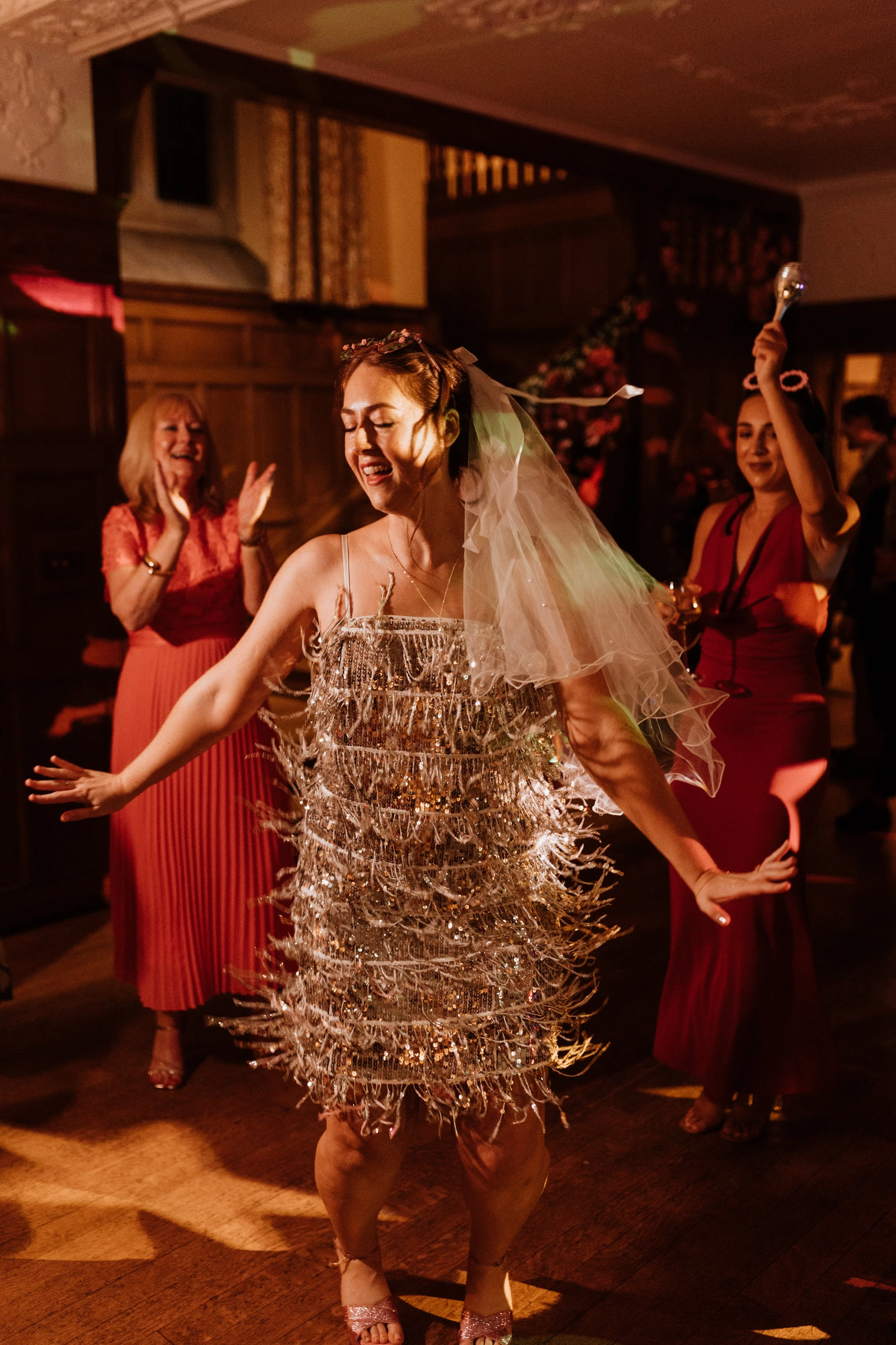  The bride spins in her sparkly dress on the dance floor at their Lake District wedding. 