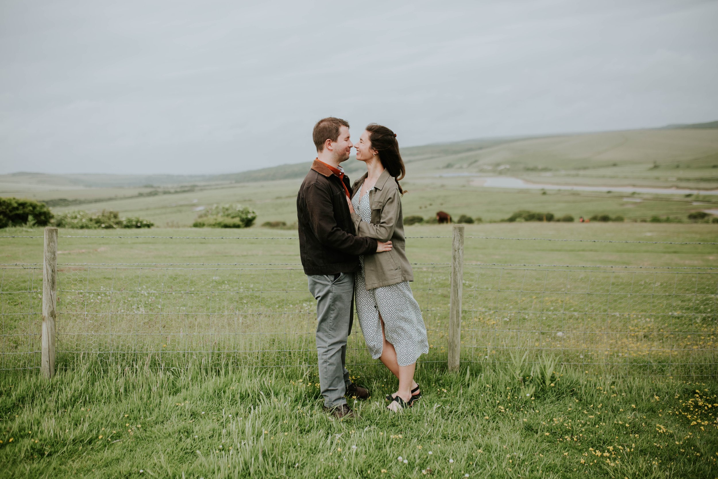 Engaged couple laughing while talking about wedding plans