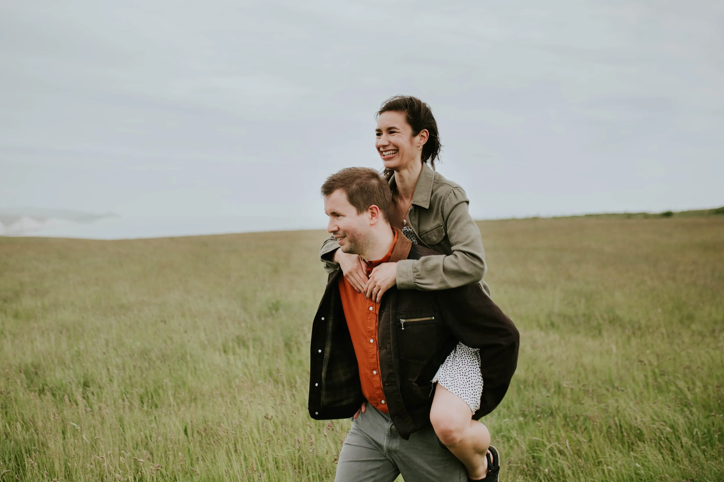 Engaged couple laughing while talking about wedding plans