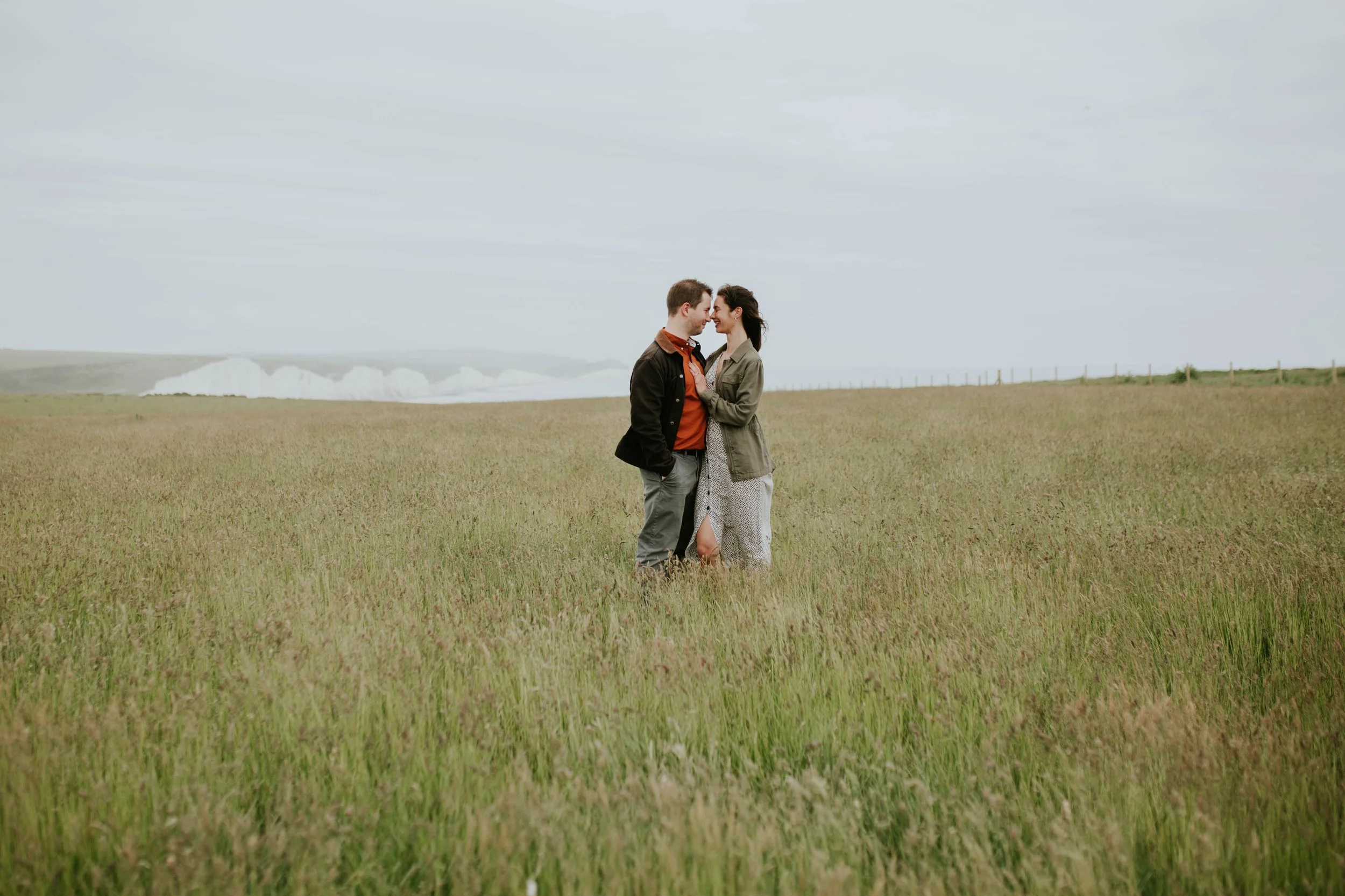 A couple share an eskimo kiss as a newly engaged couple.